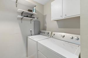 a white laundry room with a washer and dryer at The Hickory House with Firepit- Boat Ramp Access to Cedar Creek Lake in Tool