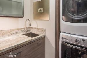 a kitchen with a sink and a microwave at Park Haus on Main Street in Historic Old Town Hosted by Nestique in Park City +40 photos
