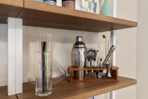 a shelf with a glass vase and utensils on it at The Hickory House with Firepit- Boat Ramp Access to Cedar Creek Lake in Tool