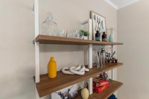 a room with wooden shelves with bottles and glasses at The Hickory House with Firepit- Boat Ramp Access to Cedar Creek Lake in Tool