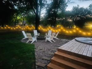 a group of white chairs and a fire pit at night at The Hickory House with Firepit- Boat Ramp Access to Cedar Creek Lake in Tool