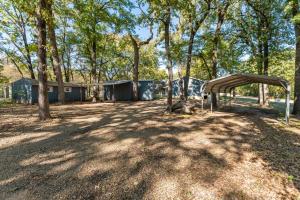 a park with a tent and trees in a field at The Hickory House with Firepit- Boat Ramp Access to Cedar Creek Lake in Tool
