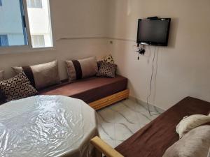 a living room with a couch and a flat screen tv at Luxury Cosy Apartment in Al Hoceima, Morocco in Al Hoceïma