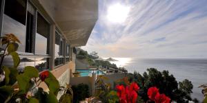a house with a view of the ocean at Celtic Manor Boutique Guest House in Gordonʼs Bay