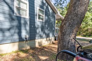 a house with a hose hooked up to a tree at The Hickory House with Firepit- Boat Ramp Access to Cedar Creek Lake in Tool