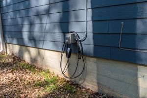 a hose is attached to the side of a house at The Hickory House with Firepit- Boat Ramp Access to Cedar Creek Lake in Tool