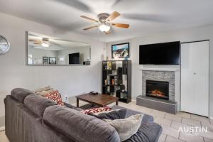 a living room with a couch and a fireplace at 2 Miles to DT Updated Pet-Friendly Home for Four in Austin
