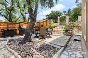 a patio with a tree and a grill at Lakeway Hideaway Cool Spot by The Colorado River in Austin