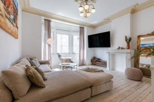 a living room with a couch and a fireplace at Huswell - Relaxing Holiday Home with Private Sauna in Ostend