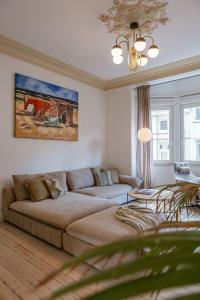 a living room with a couch and a table at Huswell - Relaxing Holiday Home with Private Sauna in Ostend