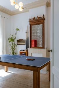 a ping pong table in a living room at Huswell - Relaxing Holiday Home with Private Sauna in Ostend