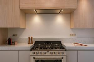 a kitchen with a stove top oven in a kitchen at Huswell - Relaxing Holiday Home with Private Sauna in Ostend