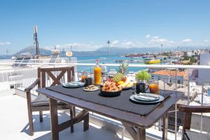 a table with food on top of a balcony at Vip penthouse patra in Patra