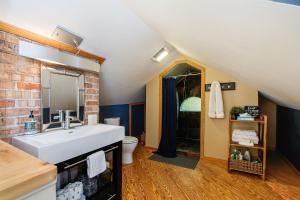 a bathroom with a sink and a brick wall at Lake Michigan Retreat- Upper Duplex in Benton Harbor +45 photos