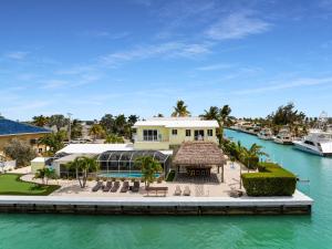 a house on the water next to a marina at Manatee Bay in Key Colony Beach