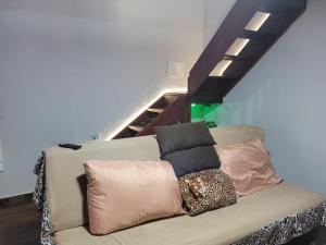 a couch with pillows on it in a room at Casa inteira Chale e Edicula in Itanhaém +148 photos