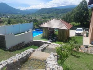 a villa with a swimming pool and a house at Villa Panorama in Bihać