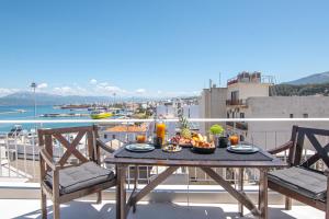 a table with a bowl of fruit on a balcony at Vip penthouse patra in Patra
