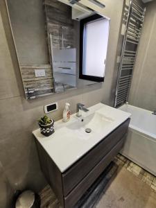 a bathroom with a sink and a mirror and a tub at Lake&Stars - Il lago e le stelle in Ispra