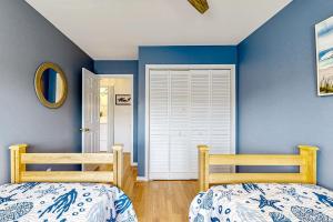 two beds in a bedroom with blue walls at Westwood --- 828 Westwood Unit D in Bethany Beach +21 photos