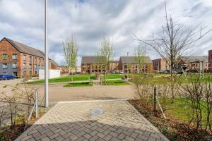 a parking lot in front of a brick building at Bright, modern 2 bedroom house with free parking! in Edinburgh