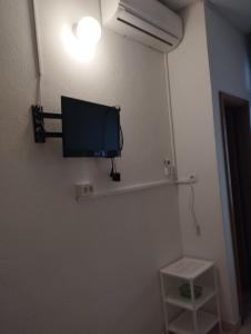 a flat screen tv on the wall of a room at Guest house Milic in Makarska