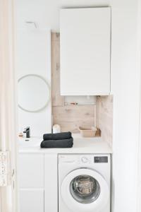 a white laundry room with a washing machine at Appartement Cosy and Quiet Paris Villette in Le Pré-Saint-Gervais