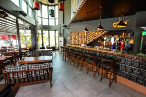 a restaurant with a bar with chairs and tables at Brand Business Hotel in Çorlu