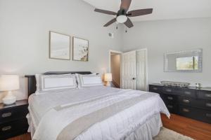 a bedroom with a bed and a ceiling fan at 2625 Forest Ridge - Pool - Tennis - Pickleball - Large Deck in Fernandina Beach +21 photos