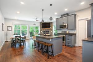 an open kitchen with a dining room and kitchen island at Townsend Gem: Retreat with Hot Tub & Fire Pit in Townsend