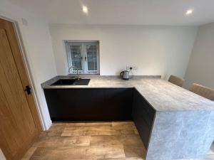 a kitchen with a sink and a counter top at The Workshop in Steep