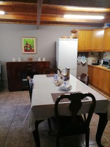 a kitchen with a table with chairs and a refrigerator at Studio P & P Polylimnio Waterfalls in Dhouvraíika