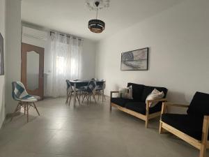 a living room with a couch and chairs and a table at La Finestra sul Borgo in Campomarino