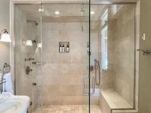 a bathroom with a shower with a glass door at Modern Vintage Vibe Condo in Milwaukee +23 photos