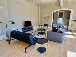 a living room with a couch and two tables at Modern Vintage Vibe Condo in Milwaukee