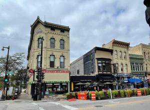 a street with two tall buildings on a city street at Modern Vintage Vibe Condo in Milwaukee