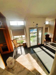 a room with aoyer with a door and a room with at Hotel Jorge V in Mirandela