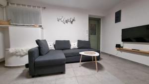 a living room with a couch and a table at G-House Skiathos in Skiathos