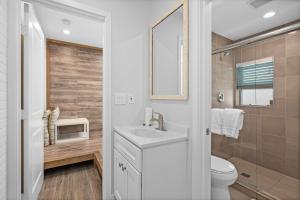 a white bathroom with a sink and a toilet at 1628 West Oceanfront Oasis - All Units in Newport Beach +75 photos