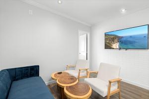 a living room with a couch and two chairs at 1628 West Oceanfront Oasis - 4,6,7 in Newport Beach