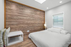 a bedroom with a bed and a wooden wall at 1628 West Oceanfront Oasis - 4,6,7 in Newport Beach