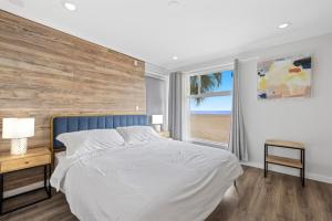 a bedroom with a large bed with a wooden wall at 1628 West Oceanfront Oasis 4,5,6,7,8,9 in Newport Beach