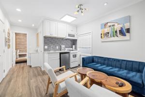 a living room with a couch and a table at 1628 West Oceanfront Oasis 4,5,6,7,8,9 in Newport Beach