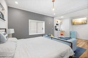 a bedroom with a large white bed and a window at 1628 West Oceanfront Oasis 3 in Newport Beach