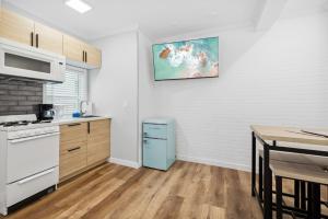 a kitchen with a blue refrigerator next to a table at 1628 West Oceanfront Oasis 3 in Newport Beach +13 photos