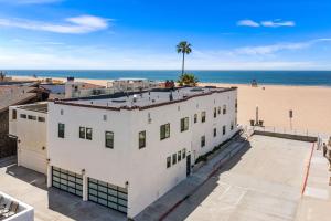 an aerial view of a white building next to the beach at 1628 West Oceanfront Oasis 3 in Newport Beach