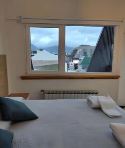 - une chambre avec une grande fenêtre offrant une vue dans l'établissement Aunaisin - Toluken apartamentos, à Ushuaia