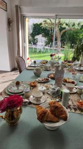 a table with plates of food and bread on it at Le clos Pascaline in Noyers-sur-Cher