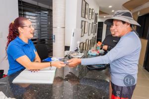 a woman and a man standing at a table at Hotel Chayrama in Santa Marta +86 photos