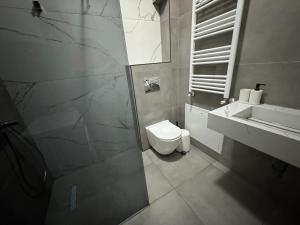 a bathroom with a toilet and a sink at Gigi Apartment by eluxory in Skopje